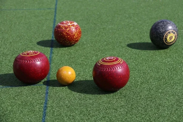4 bowls and a jack on a green