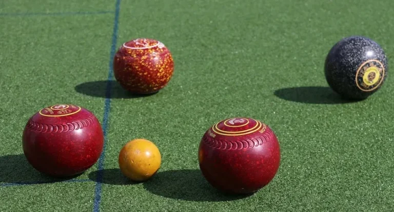 4 bowls and a jack on a green